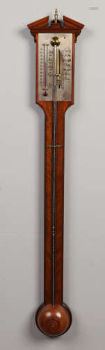 A 20th century Georgian style mahogany stick barometer with silvered dial and adjuster. Having