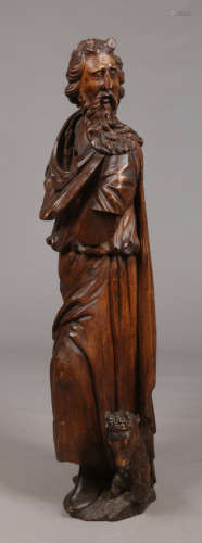 A 19th century Continental carved walnut sculpture of Saint John the Baptist dressed in flowing