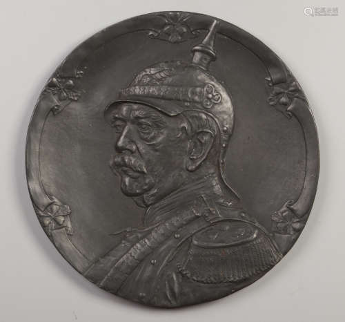 A German pewter relief work wall plaque. Portrait of Otto von Bismarck wearing a cuirassier