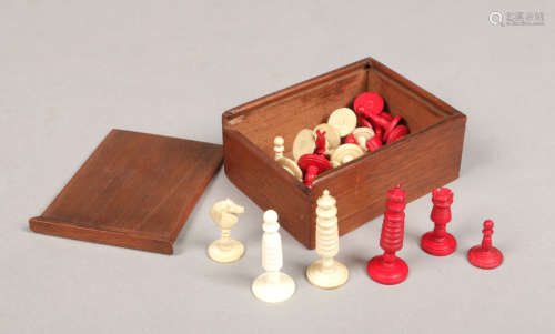An early 20th century Indian export carved bone and ivory polychrome miniature chess set in wooden
