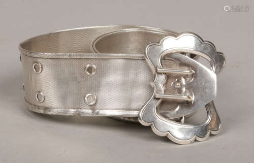 A white metal woven belt with engraved buckle.