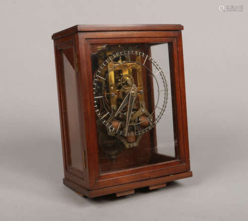 A mahogany cased patent electric skeleton clock by the Self Winding Clock Company of New York.
