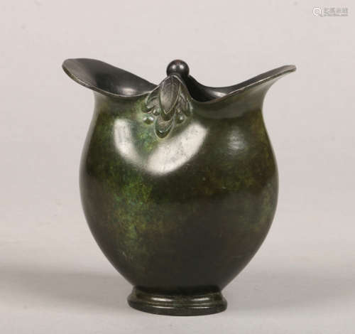 An Art Nouveau verdigris bronze double lipped vase decorated with clusters of stylized leaves, 12.