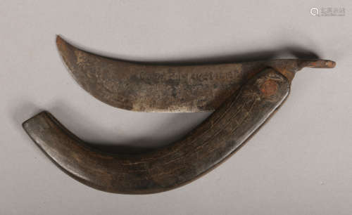 A 19th century folding pruning knife with horn handle and cyrillic inscription to the blade, 22cm.