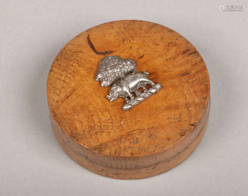 A Victorian circular bur elm trinket box and cover. Surmounted by a silver crest of a wild boar