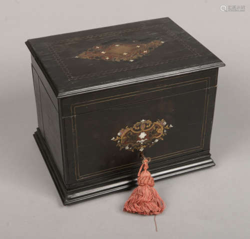 A Victorian ebonized and fitted liqueur cabinet. With brass strung inlay and marquetry panels.