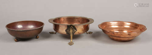 A Dryad Arts & Crafts planished copper bowl with cable rim and raised on three ball feet, marked