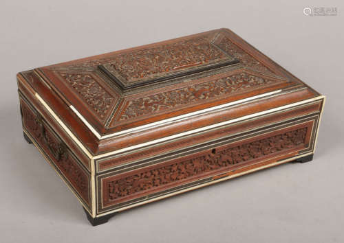 A 19th century Anglo Indian carved and inlaid fitted box of sarcophagus form and raised on bracket