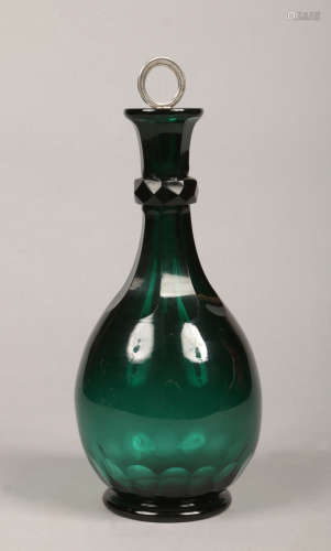 An early 19th century emerald glass decanter, flat cut and with silver mounted stopper, 31cm.