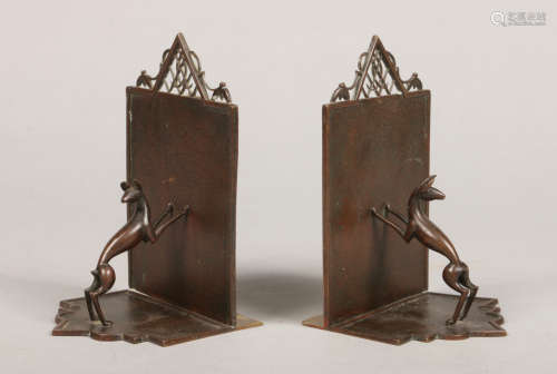 A pair of Austrian Art Deco bronze bookends. With textured grounds, openwork pediments and each