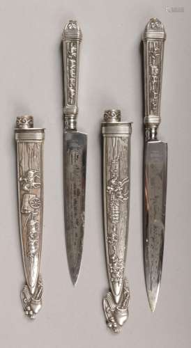 Two French Gaucho style knives, maker Inox. Each with embossed white metal handle and sheath