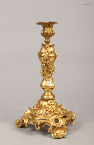 A late 19th / early 20th century French Neo-Rococo ormolu table candlestick. Cast with shell motifs,