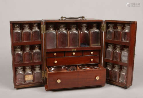 An early 19th century mahogany fitted travelling medicine chest or apothecary cabinet. With brass