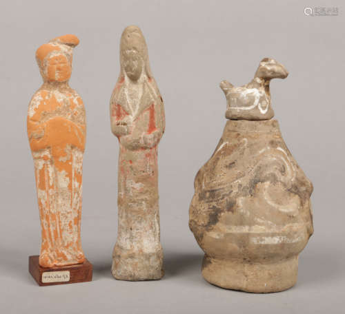 Two Chinese Tang Dynasty earthenware burial figures with remnants of pigment decorations along