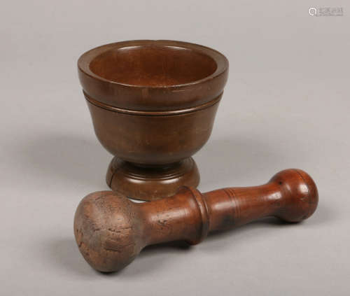 A 19th century Continental turned fruitwood mortar and pestle, 12.5cm diameter.Condition report