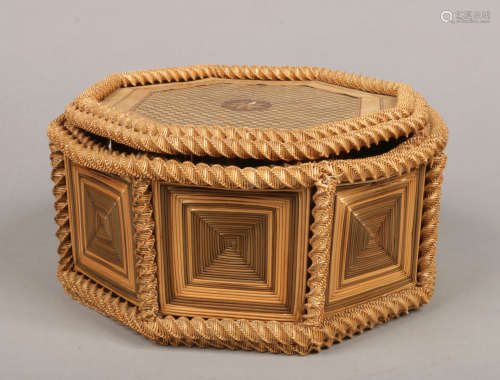 An octagonal straw work box and cover. With chequered top having star patera and with twist supports