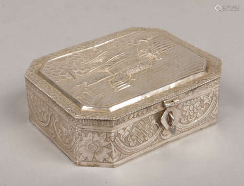 An eastern white metal casket with hinged cover. Decorated in relief with a pagoda scene, 15cm wide.