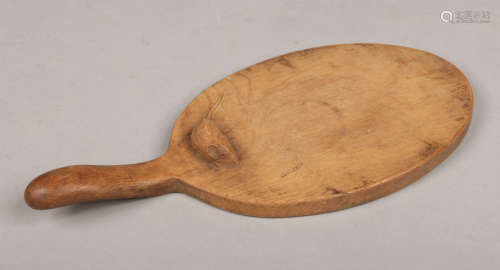 Robert Thompson of Kilburn, North Yorkshire. A Mouseman carved oak cheese board with handle of