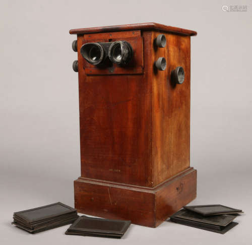 A mahogany cased sterescopic viewer of pedestal form and with adjustable eyepieces. The internal