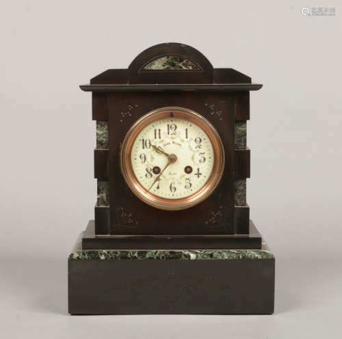 A Victorian slate and antico verde marble mantel clock. Housing a French 8 day cylinder movement
