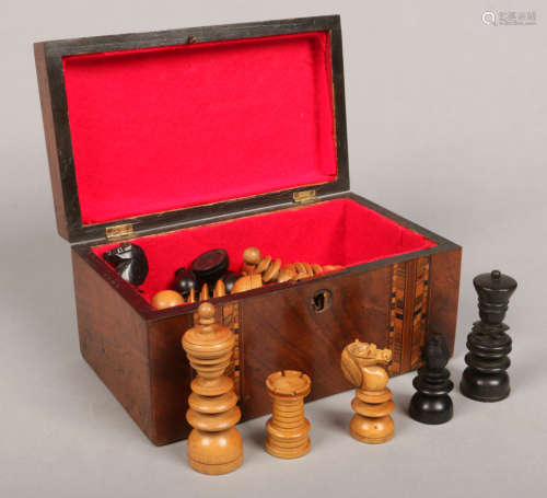 A carved and ebonized wooden chess set in Victorian inlaid walnut box. King pieces 10cm.Condition