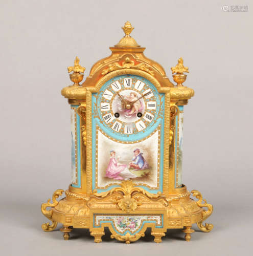 An early 20th century French gilt bronze mantel clock set with Sevres style panels painted with a