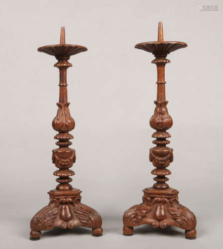 A pair of late 19th / early 20th century French carved walnut candle pricket stands. With acanthus