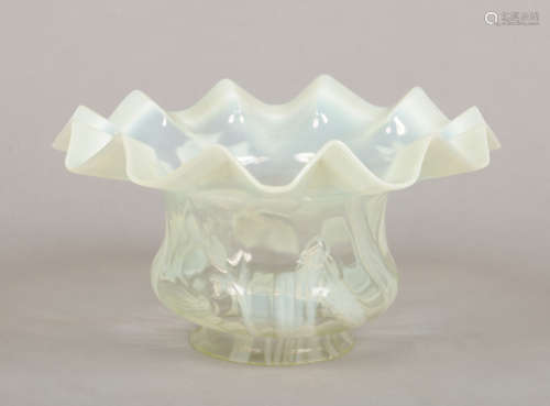 A Victorian vaseline glass oil lamp shade. Moulded with flowers and with frilled rim, 26cm wide,