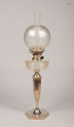 An Edwardian oil lamp by Hawksworth Eyre & Co. With frosted glass shade, cut glass font and raised