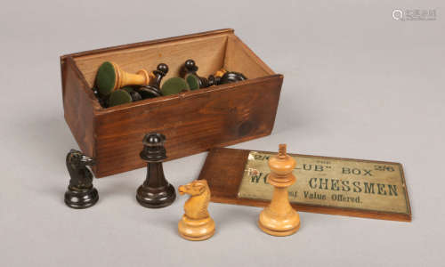 A carved and ebonized wooden chess set of Staunton style in Club box. King pieces 6.5cm.Condition