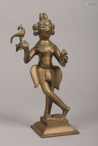 An 18th century Indian bronze statue of a deity holding a bird and a lotus flower, 26cm.Condition