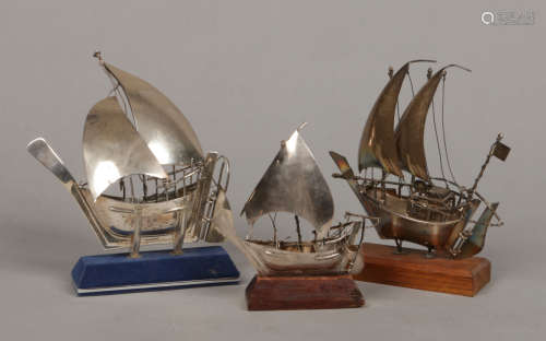 Three mid 20th century silver models of sailing boats on stands. Largest 20cm.