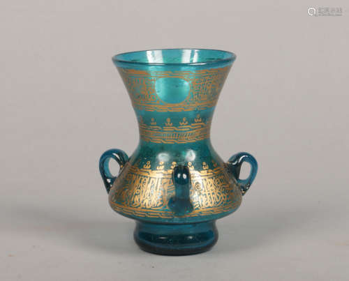 A 19th century blue glass mosque lamp. With three loop handles, bubble inclusions and gilt bands