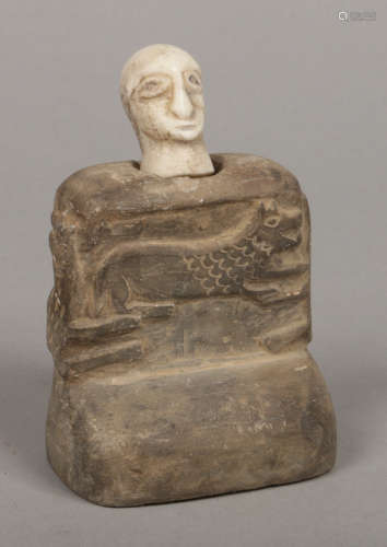 A Bactrian carved stone two piece idol decorated to the seated figures chest with a stylized fox,