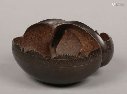A coco de mer basket. With egg and dart carved rim and incised banded border, 28cm.