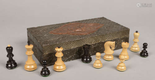 A carved and ebonized wooden chess set of Staunton style with weighted pieces in pewter mounted box.