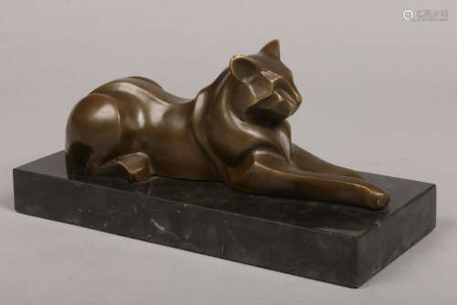 An Art Deco style bronze sculpture after Michel DeCoux. Formed as a recumbent wild cat on a slate