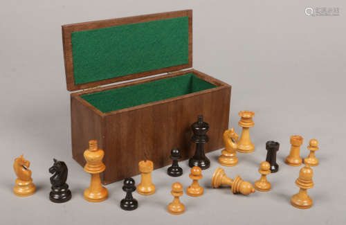 A carved and ebonized wooden chess set of Staunton style in box. King pieces 7cm.Condition report