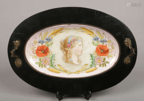 A Victorian serving dish with painted pottery well depicting a maiden and flowers under an