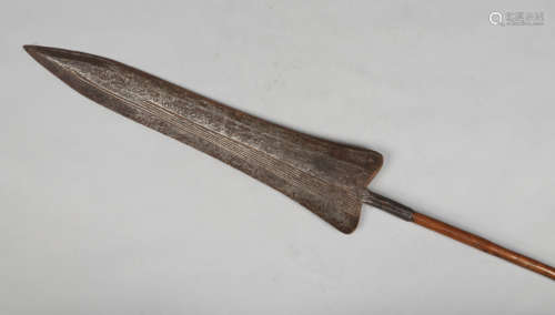 An African spear with wide flattened blade having reeded decoration, 204cm.