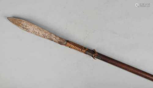 An African spear, the blade attached with woven vegetable strands and the shaft formed from two