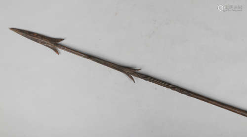 An African spear with barbed and twisted blade, metal mounts and geometric carved details, 155cm.
