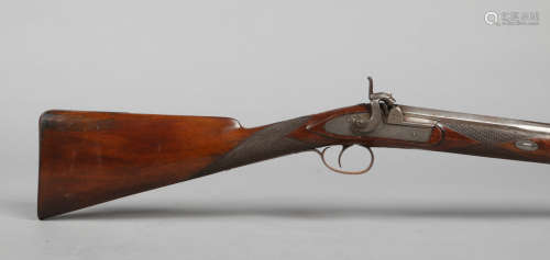 An early 19th century percussion cap muzzle loading rifle. With carved walnut halfstock and ramrod
