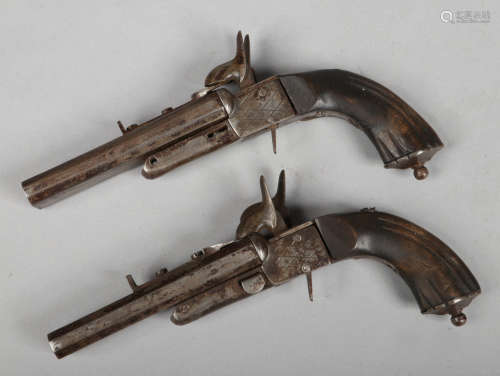 A pair of 19th century box lock percussion double barrel pistols with concealed triggers, barrel