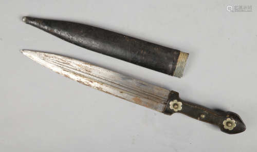 An eastern hunting dagger with hardwood grip and leather mounted scabbard. Blade length 27cm