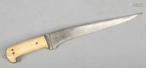 An eastern hunting knife with bone scales, 39cm.Condition report intended as a guide only.Pitted.