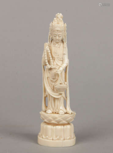 A 19th century Chinese carved ivory figure of Guanyin. Modelled holding a rosary and a basket and