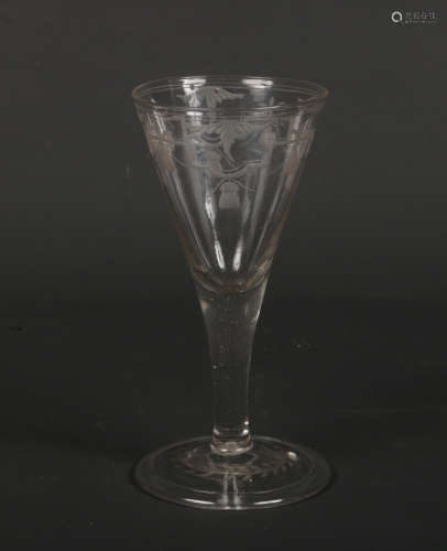 An 18th century wine glass with conical shaped bowl and folded foot. Engraved with a lambrequin