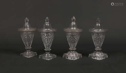 Two pairs of Georgian flat cut glass confitures and covers raised on square lemon squeezer bases,