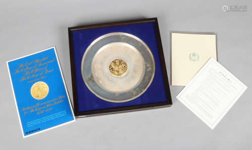 A Danbury Mint silver and silver gilt commemorative plate in hanging display case. In memoration